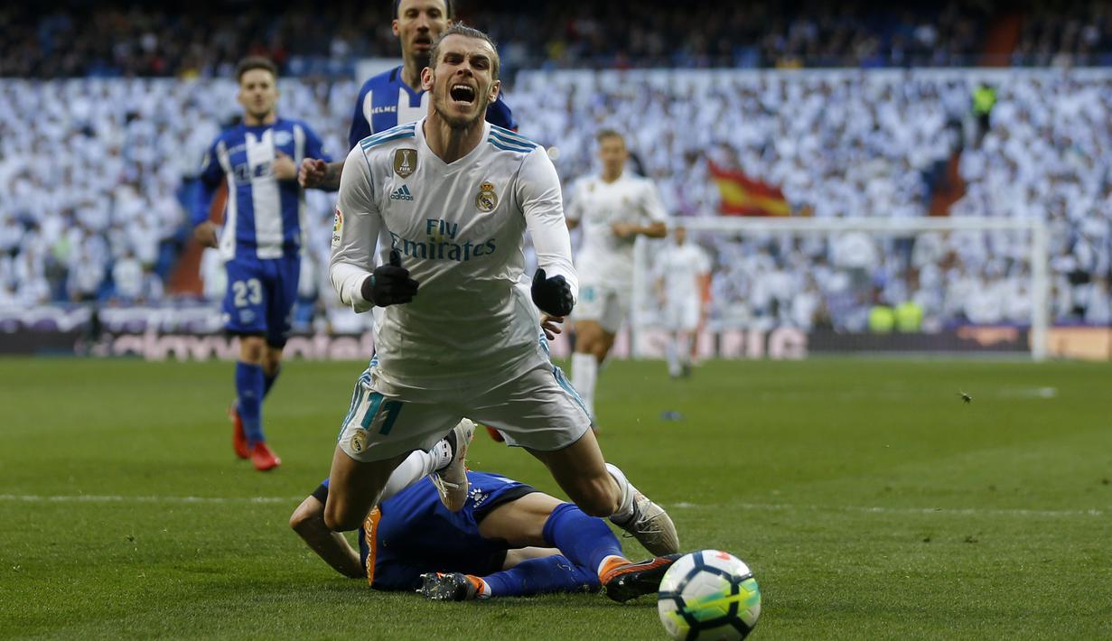 Pemain Real Madrid, Gareth Bale jatuh saat berebut bola dengan pemain Alaves pada La Liga Santander di Santiago Bernabeu stadium, Madrid, (24/2/2018). Real Madrid menang 4-0. (AP/Francisco Seco)
