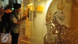 Pengunjung mengamati koleksi Museum Wayang di Kota Tua, Jakarta, Jumat (8/7). Selama liburan lebaran, pengunjung Museum Wayang meningkat hingga empat kali lipat dari hari biasa. (Liputan6.com/Gempur M Surya)