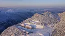 Foto dari udara yang diabadikan pada 20 Desember 2020 ini menunjukkan pemandangan objek wisata Longtoushan saat matahari terbit di Distrik Nanzheng di Hanzhong, Provinsi Shaanxi, China. Saat musim dingin, hamparan salju yang putih menjadi hal yang indah untuk dinikmati. (Xinhua/Tao Ming)