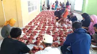 Foto: Umat non muslim membantu umat muslim saat penyembelihan hewan kurban di masjid (Liputan6.com/Dion)