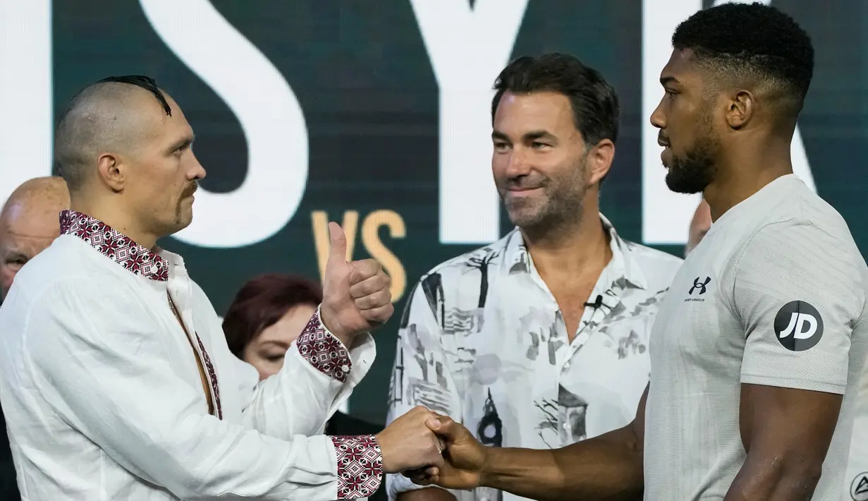Petinju Inggris Anthony Joshua (kanan) dan petinju Ukraina Oleksandr Usyk (tengah kiri) saling pandang saat penimbangan di King Abdullah Sports City, Jeddah, Arab Saudi, 19 Agustus 2022. Joshua dijadwalkan melawan juara bertahan Usyk dalam pertandingan ulang tinju kelas berat di Jeddah pada 20 Agustus. (AP Photo/Hassan Ammar)