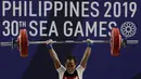 Lifter Suratman melakukan angkatan saat SEA Games 2019 cabang angkat besi nomor 55 kg di Stadion Rizal Memorial, Manila, Minggu (1/12). Dirinya meraih perak dengan total angkatan 250 kg. (Bola.com/M Iqbal Ichsan)