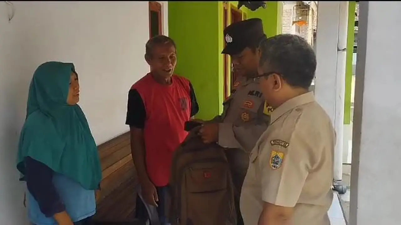 Pak Bhabin dan perangkat desa Banjardawa, Pemalang mengantar tas ke rumah warga. (Foto: Liputan6.com/Humas Polres Pemalang)