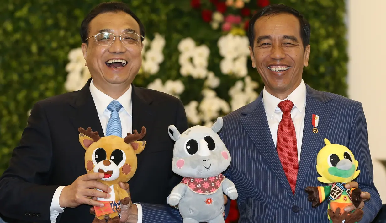 Presiden Joko Widodo memegang boneka maskot Asian Games 2018 saat berfoto bersama dengan Perdana Menteri China Li Keqiang di Istana Bogor (7/5). Pertemuan itu untuk menyepakati dua poin kerjasama. (AFP/Pool/Dita Alangkara)