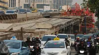 Sejumlah pengguna jalan melintas di sisi pembangunan jalan layang Kuningan Selatan, Jakarta, Kamis (17/9/2015). Pembangunan jalan layang ini membuat kemacetan hampir setiap hari. (Liputan6.com/Helmi Fithriansyah)