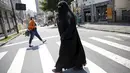 Gisele Marie melintasi jalan setelah latihan di sebuah studio, Sao Paulo (15/9/2015). Banyak orang disekitarnya terkejut melihat seorang wanita Muslim yang menggunakan Burka memainkan musik metal. (REUTERS/Nacho Doce)