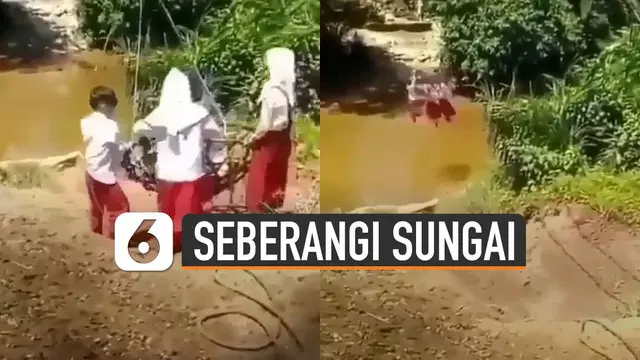 Miris dan ngeri ketika melihat tiga bocah SD ini menyeberangi sungai dengan bergelantungan di sebuah keranjang.