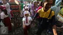 Orangtua mengantarkan anaknya masuk kelas usai upacara pada hari pertama sekolah di SDN Pasar Baru 05 Jakarta, Senin (18/7). Usai libur Idul Fitri, para siswa kembali mengikuti pelajaran di sekolah untuk tahun ajaran 2015-2016 (Liputan6.com/Faizal Fanani)
