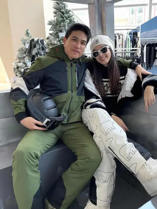 Potret terbaru Nong Poy dan Oak mengenakan busana snowboardnya. Poy tampil dengan tampilan hitam putih dari bennie, jaket dan celananya. [@poydtreechada]