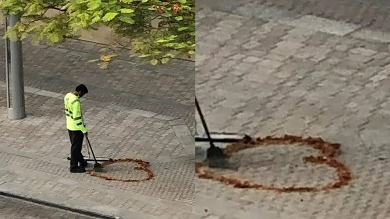 Rindu Istri, Petugas Kebersihan Ini Gambar Hati dengan Daun Kering di Jalan