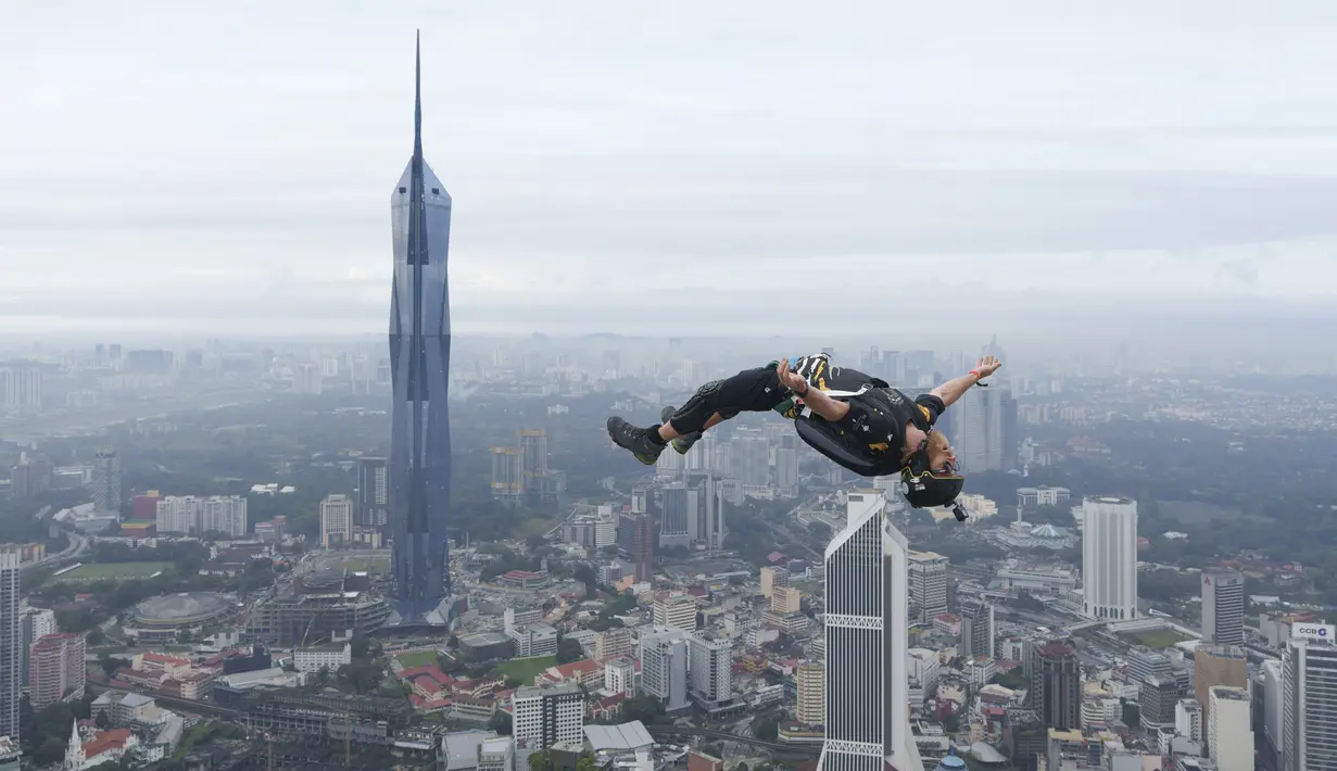 Seorang pelompat BASE terjun dari Menara Kuala Lumpur selama KL Tower International Jump Malaysia di Kuala Lumpur, Jumat (3/2/2023). BASE adalah akronim untuk empat jenis objek tetap yang bisa diambil oleh para jumper dalam olahraga, termasuk bangunan, antena, bentang (yang mencakup jembatan), dan Bumi (seperti bagian atas tebing). (AP Photo/Vincent Thian)