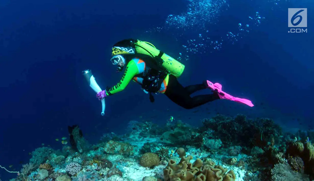 Ketua Umum WASI, Tri Suswati Karnavian membawa api obor Asian Games 2018 di perairan Pulau Piaynemo, Raja Ampat, Papua Barat, Kamis (26/7). Kegiatan ini sebagai bentuk dukungan perempuan terhadap kesuksesan Asian Games 2018. (Liputan6.com/HO/Mabes Polri)
