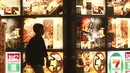 Seorang pria berjalan melewati cahaya iklan restoran di sepanjang jalan di Tokyo, Jepang, 4 Oktober 2021. Warga kembali beraktivitas setelah berakhirnya status pembatasan darurat virus corona COVID-19 di Jepang. (AP Photo/Koji Sasahara)