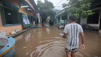 Hujan yang mengguyur wilayah Kabupaten Tangerang sejak Rabu (14/2/2024) dini hari, membuat sejumlah tempat mengalami kebanjiran, terlebih akses menuju Tempat Pemungutan Suara (TPS) Pemilu 2024. (Foto: Pramita Tristiawati/Liputan6.com).
