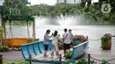 Wisatawan berfoto saat mengunjungi Senayan Park, Jakarta, Rabu (9/12/2020). Libur Nasional Pilkada Serentak 2020 dimanfaatkan sebagian warga Jakarta dan sekitarnya untuk mengunjungi tempat rekreasi bersama keluarga. (Liputan6.com/Faizal Fanani)