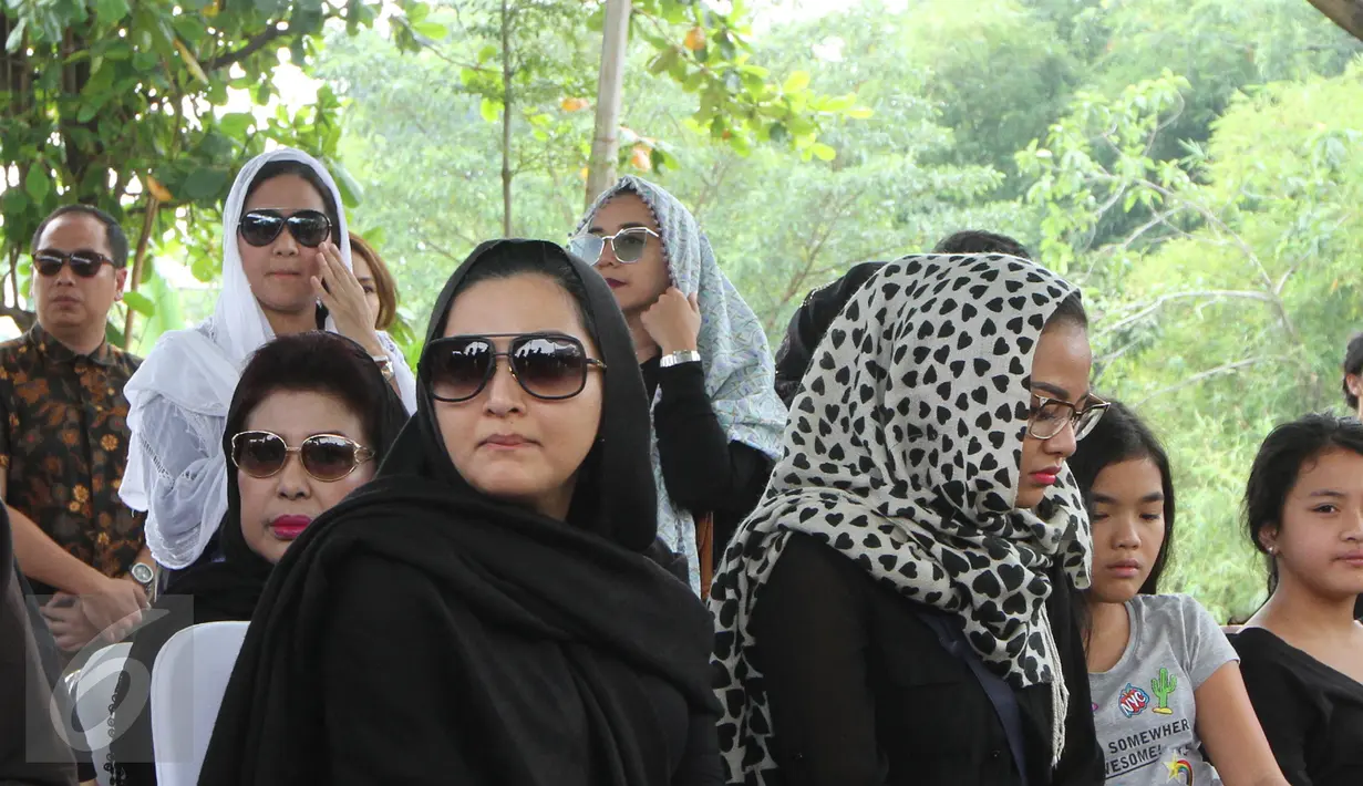 Penyanyi Ashanty ditemani Aurel Hermansyah selama prosesi pemakaman sang ibunda, Ratu Farida, di TPU Jeruk Purut, Jakarta, Senin (7/11). Menurut kabar, ibunda Ashanty meninggal dunia setelah jatuh dari kamar mandi. (Liputan6.com/Herman Zakharia)