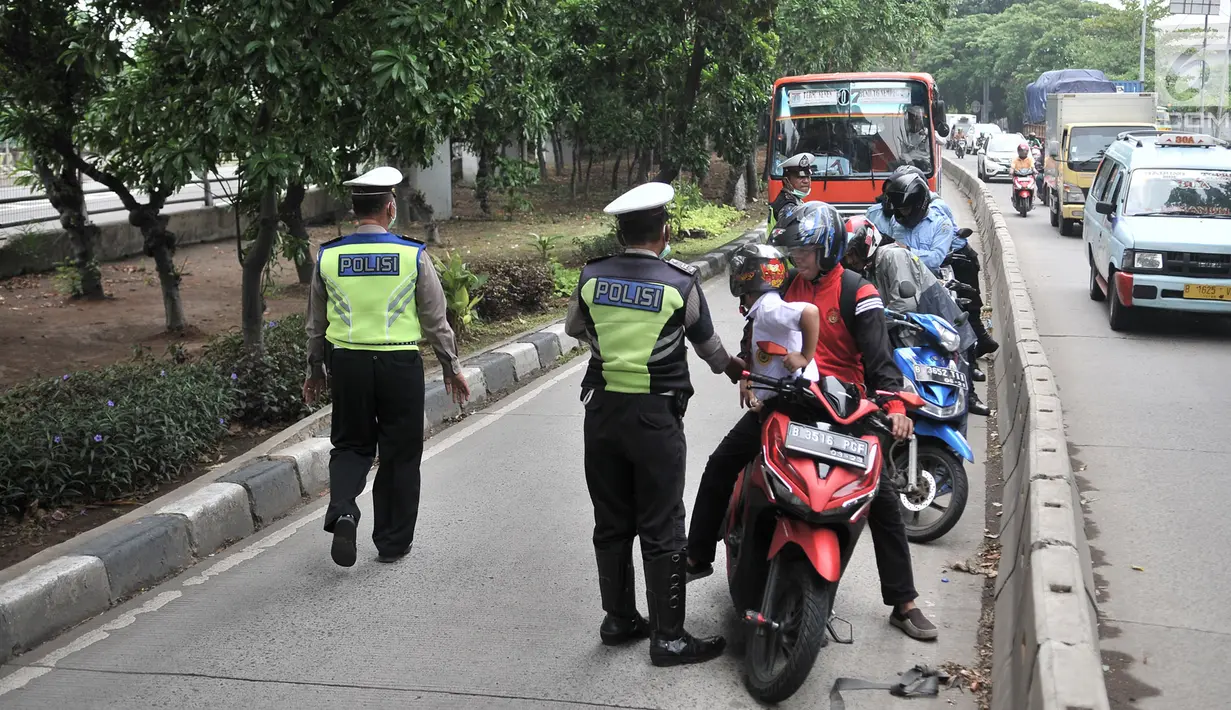 Polisi memberhentikan pengendara yang melintasi jalur bus Transjakarta di Jalan Yos Sudarso, Jakarta, Senin (21/1). Razia ini sekaligus meningkatkan kedisiplinan dalam berkendara. (Merdeka.com/Iqbl Nugroho)
