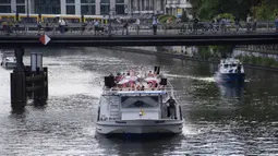 Anggota Staatsballett Berlin menari di atas kapal pesiar selama tur melalui pusat kota di Berlin, Jerman, Kamis (10/6/2021). Pertunjukan itu diikuti oleh banyak orang di sepanjang rute. (Paul Zinken/dpa via AP)