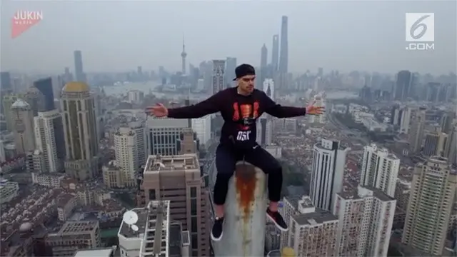 Seorang Pria nekat memanjat hingga ke ujung pilar gedung pencakar langit di Shanghai tanpa alat pengaman.