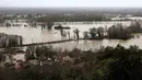 Curah hujan ekstrem selama lebih dari 35 hari berturut-turut, diperparah oleh Badai Nils dan Badai Pedro, memicu banjir yang mencapai level historis. Tampak foto menunjukkan kondisi rumah-rumah yang terendam banjir setelah hujan lebat yang menyebabkan banjir Sungai Garonne di Sainte-Croix-du-Mont, Prancis barat pada Kamis 19 Februari 2026. (ROMAIN PERROCHEAU/AFP)