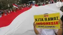 Massa yang tergabung dalam Masyarakat Penegak Demokrasi (MPD) menggelar aksi damai "Menyambut Pelantikan Presiden dan Wapres RI Terpilih" di Kawasan Patung Kuda, Jakarta, Kamis (10/10). Mereka mengimbau masyarakat menjaga situasi aman dan damai jangan terprovokasi. (Liputan6.com/Herman Zakharia)