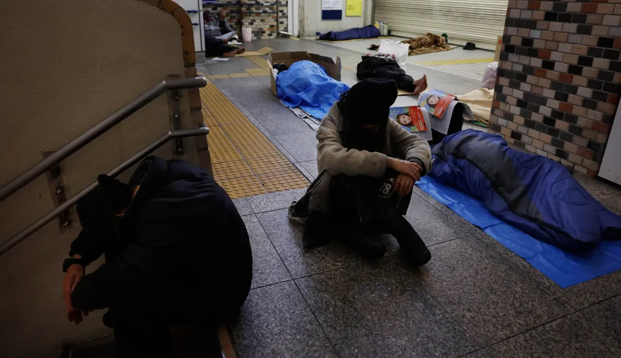 Para tunawisma tidur di lantai Stasiun Shinjuku, Tokyo, Jepang, Kamis (9/1/2020). Seperti Amerika Serikat, Jepang memiliki tingkat kemiskinan yang relatif tinggi untuk negara kaya. (AP Photo/Jae C. Hong)