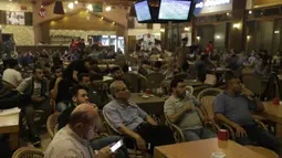 Warga Palestina menonton laga El Clasico antara Barcelona melawan Real Madrid di Gaza City, Minggu (6/5/2018). Konflik perang tak menyurutkan fenomena El Clasico. (AFP/Mahmud Hams)
