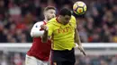 Bek Arsenal, Shkodran Mustafi, duel udara dengan striker Watford, Troy Deeney, pada laga Preimer League di Stadion Emirates, Minggu (11/3/2018). Arsenal menang 3-0 atas Watford. (AP/Matt Dunham)