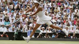 Aksi Garbine Muguruza mengembalikan bola saat melawan Magdalena Rybarikova pada laga semifinal tunggal putri Wimbledon 2017 di London, (13/7/2017). (AP/Kirsty Wigglesworth)