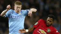 Gelandang Manchester City, Kevin De Bruyne berebut bola dengan gelandang Manchester United, Fred pada pertandingan semifinal Piala Liga Inggris di stadion Etihad, Manchester, Rabu (29/1/2020). MU menang 1-0 atas City namun gagal ke final karena skor agregat 3-2. (AP Photo/Dave Thompson)