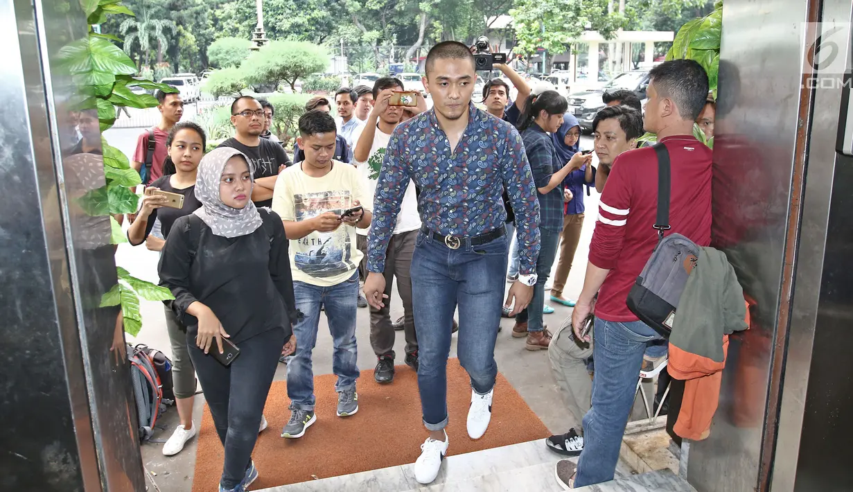 Komika Rizky Firdaus Wijaksana atau Uus memasuki gedung Ditreskrimsus Polda Metro Jaya, Selasa (24/10). Uus memberi kesaksian dari pihak Nikita Mirzani atas cuitan penghinaan terhadap Panglima TNI Jenderal Gatot Nurmantyo. (Liputan6.com/Herman Zakharia)