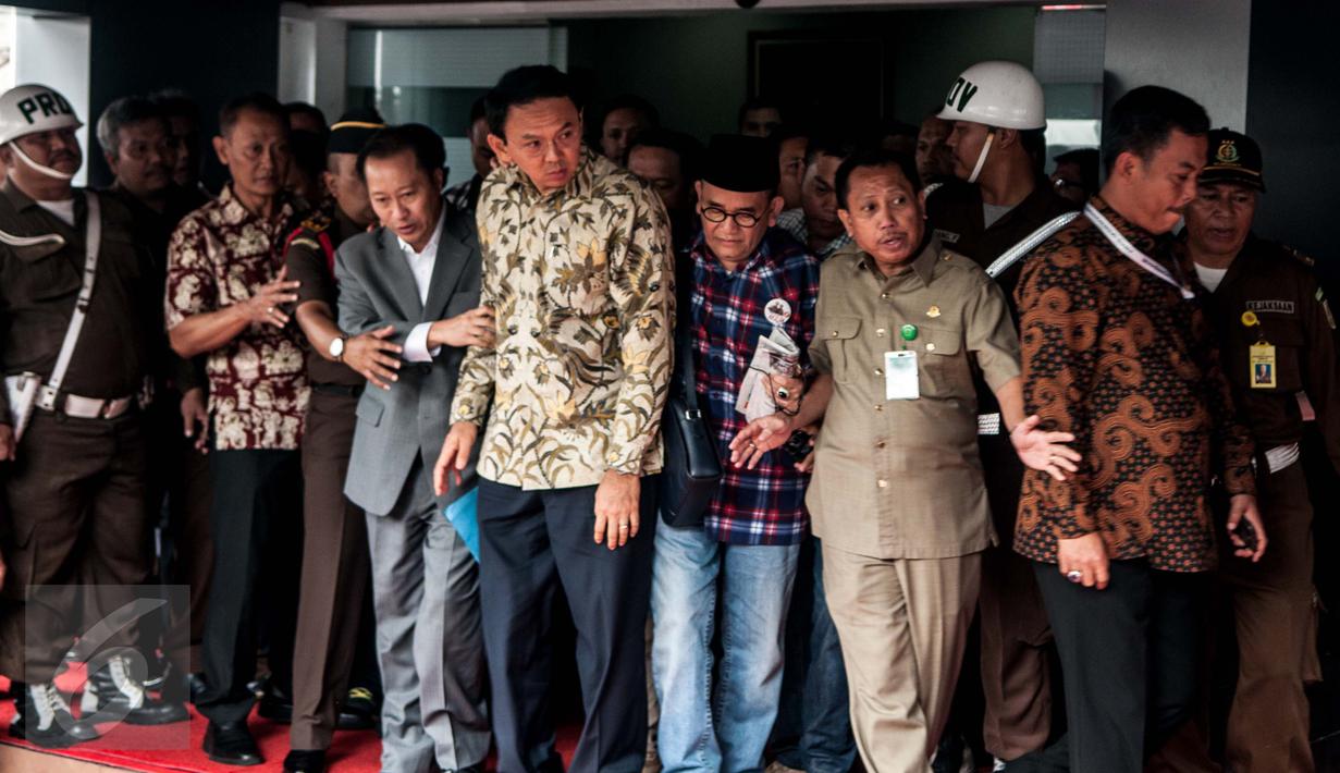Tersangka dugaan penistaan agama, Basuki Tjahaja Purnama (Ahok) keluar dari dalam Gedung Kejagung, Jakarta, Kamis (1/12). Keluarnya Ahok ini dapat dipastikan pihak kejaksaan tidak menahan gubernur nonaktif DKI Jakarta itu. (Liputan6.com/Gempur M Surya)
