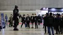 Pengunjung mengamati sebuah robot prajurit dalam Pameran Pertahanan dan Keamanan Korea Selatan  2020 di Korea International Exhibition Center di Goyang, Korea Selatan (18/11/2020). Korsel memutuskan untuk menaikkan satu level dari lima tingkat aturan social distancing. (Xinhua/Wang Jingqiang)