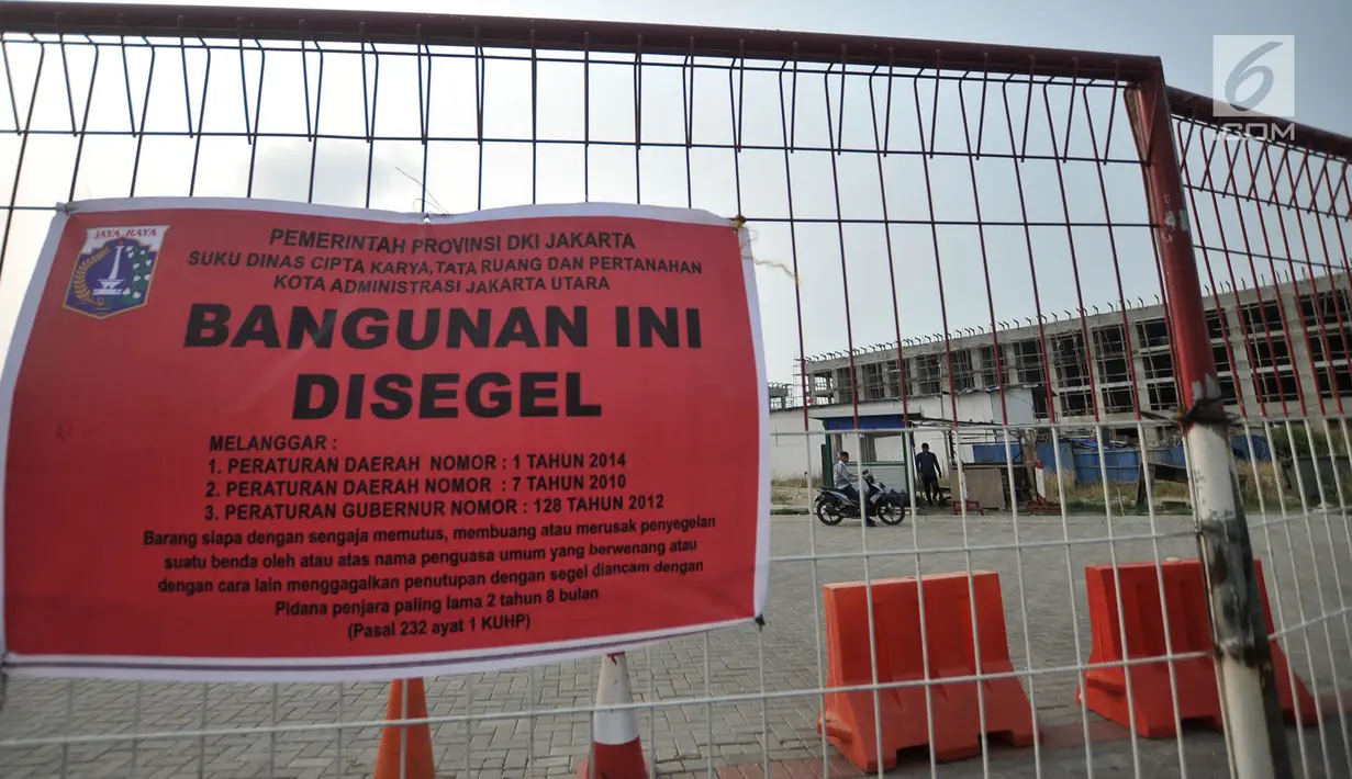 Spanduk penyegelan terpampang di pagar sebuah bangunan proyek reklamasi Pulau D, Teluk Jakarta, Kamis (7/6). Bangunan yang disegel terdiri atas 409 rumah, 212 rumah kantor, dan 313 unit rukan serta rumah tinggal yang disatukan. (Liputan6.com/IqbalNugroho)
