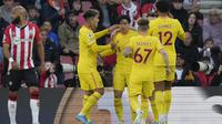 Penyerang Liverpool, Takumi Minamino (tengah) berselebrasi dengan rekan setimnya usai mencetak gol ke gawang Southampton pada pertandingan lanjutan Liga Inggris di Stadion St. Mary di Southampton, Inggris, Rabu (18/5/2022). Liverpool menang tipis atas Southampton 2-1. (AP Photo/Frank Augstein)