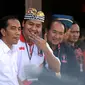 Presiden Jokowi (kedua kiri) mendengarkan penjelasan dari pengawas turnamen, Maruarar Sirait saat pembukaan turnamen Piala Presiden 2015 di Stadion Kapten I Wayan Dipta, Gianyar, Bali, Minggu (30/8/2015). (Liputan6.com/Helmi Fithriansyah)