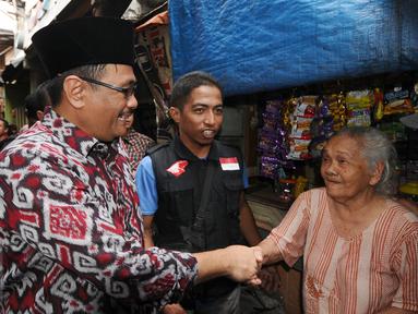 Cawagub petahana, Djarot Syaiful Hidayat menyalami warga saat sosialisasi di kawasan Pademangan VIII, Jakarta, Kamis (23/3). Selain sosialisasi dengan warga, Djarot juga menyerap keluhan warga sekitar. (Liputan6.com/Helmi Fithriansyah)  
