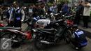 Petugas Dishub, mencabut pentil sebuah sepeda motor yang nekat parkir liar di Jakarta, Jumat (12/6/2015). Razia gabungan Dishub, Garnisun dan Satlantas bertujuan untuk mengantisipasi arus lalu lintas yang kerap macet. (Liputan6.com/Johan Tallo)