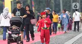 Warga mendatangi area perayaan Lebaran Betawi 2025 di lapangan Monumen Nasional (Monas), Jakarta, Sabtu (26/4/2025). (Liputan6.com/Angga Yuniar)
