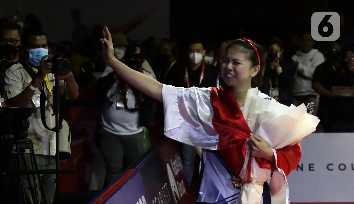 Pebulu tangkis ganda putri, Greysia Polii berkeliling lapangan dan menyapa suporter usai mengumumkan pengunduran dirinya secara resmi sebagai atlet professional di Istora Senayan Jakarta, Minggu (12/6/2022). Bersama Apriyani Rahayu, Greysia Polii mencetak sejarah dengan meraih emas di Olimpiade Tokyo 2020. (Liputan6.com/Helmi Fithriansyah)