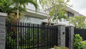 Pagar Minimalis Modern dengan Besi Hollow Hitam dan Batu Andesit/Model Pagar Rumah Kombinasi Besi Hollow dan Batu Alam (Sumber: gemini.com)