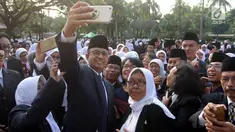 Gubernur DKI Jakarta Anies Baswedan berswafoto usai melantik dan mengambil sumpah jabatan pejabat fungsional di halaman Balai Kota DKI Jakarta, Senin (4/6). Sebanyak 916 pejabat fungsional dilantik hari ini. (Liputan6.com/Arya Manggala)