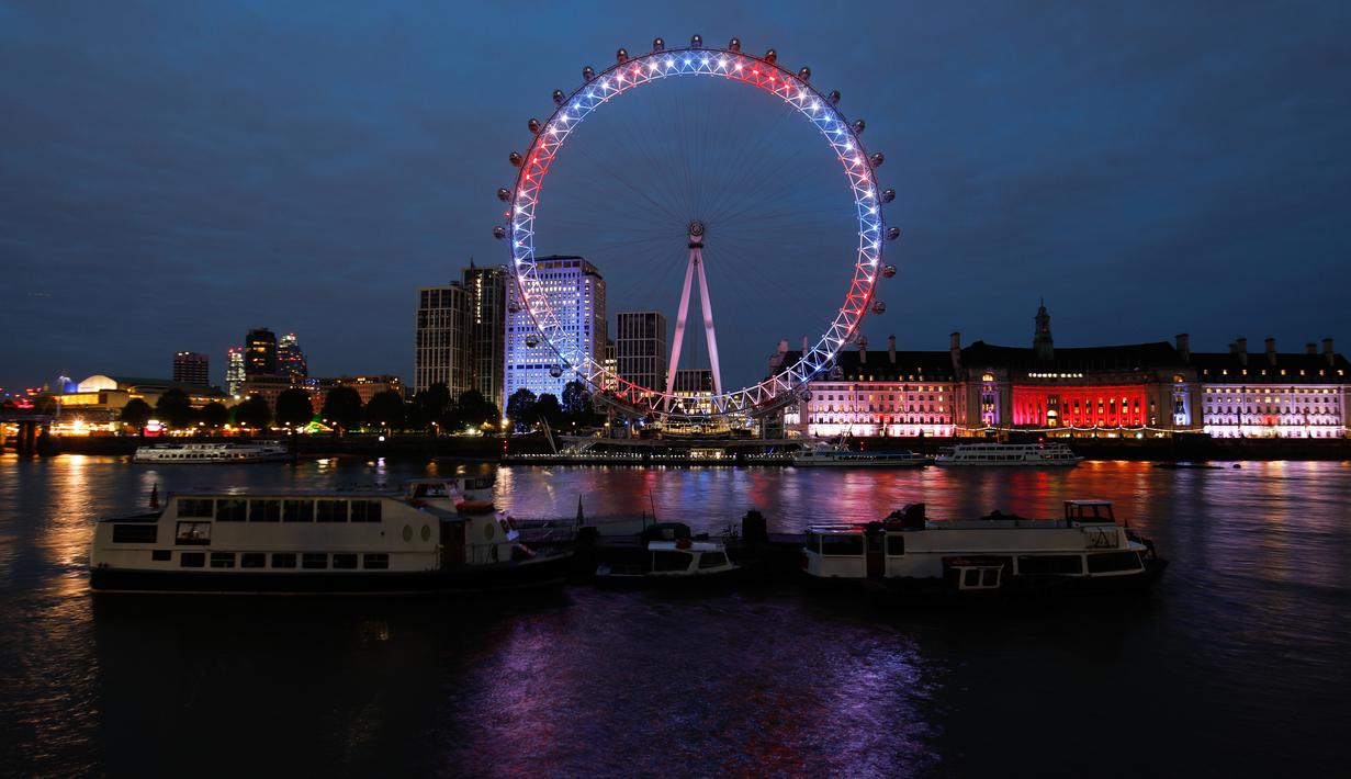Eye menyalakan lampu berwarna merah, biru dan putih untuk menghormati kelahiran bayi laki-laki  Pangeran Harry dan Meghan Markle di London, Senin (6/5/2019). Bayi yang hingga kini belum diberi nama tersebut, lahir pada pukul 5:26 pagi waktu setempat dengan berat 3,2 kg. (Tolga AKMEN/AFP)