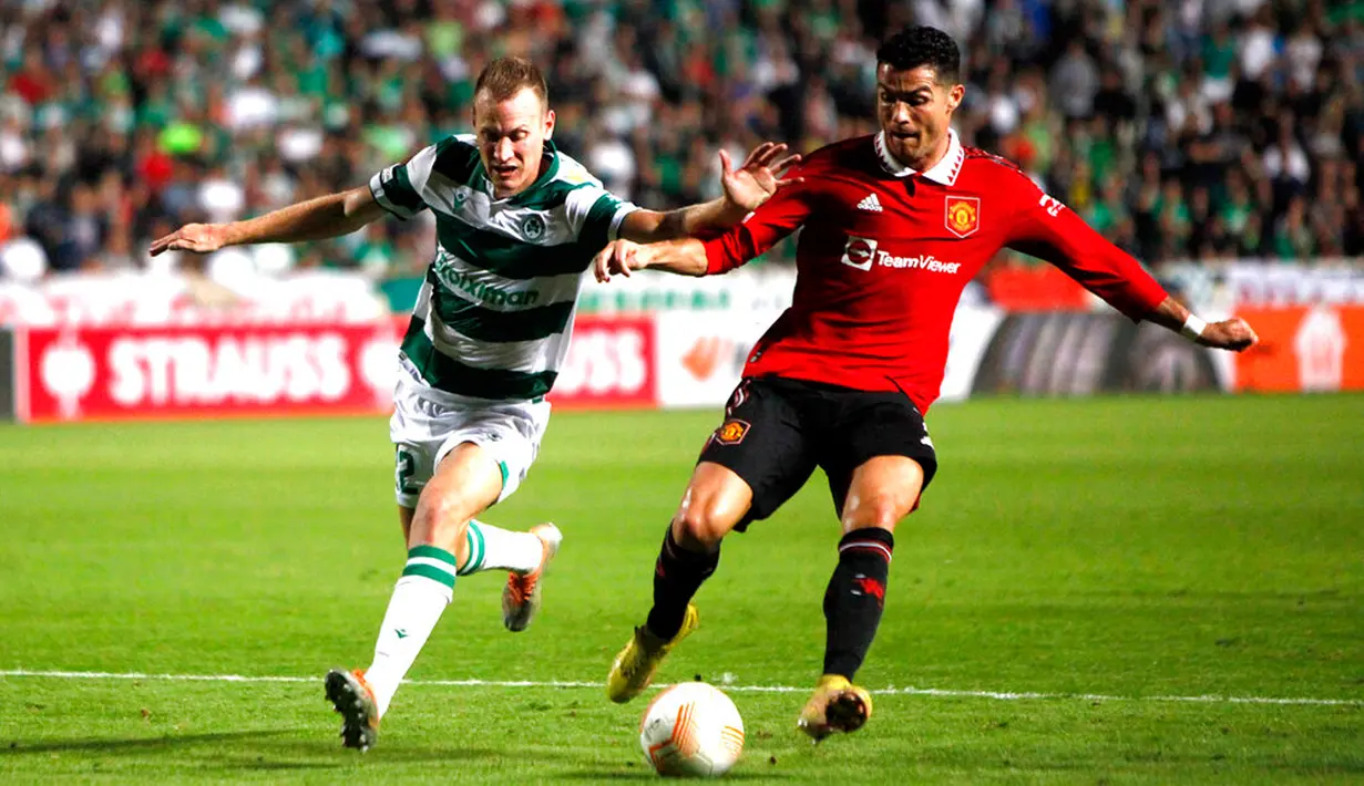 Pemain Manchester United Cristiano Ronaldo (kanan) berebut bola dengan pemain Omonia Paris Psaltis pada pertandingan sepak bola Grup E Liga Europa di Stadion GSP, Nicosia, Siprus, 6 Oktober 2022. Manchester United menang 3-2 atas Omonia. (AP Photo/Maria Karadjias)