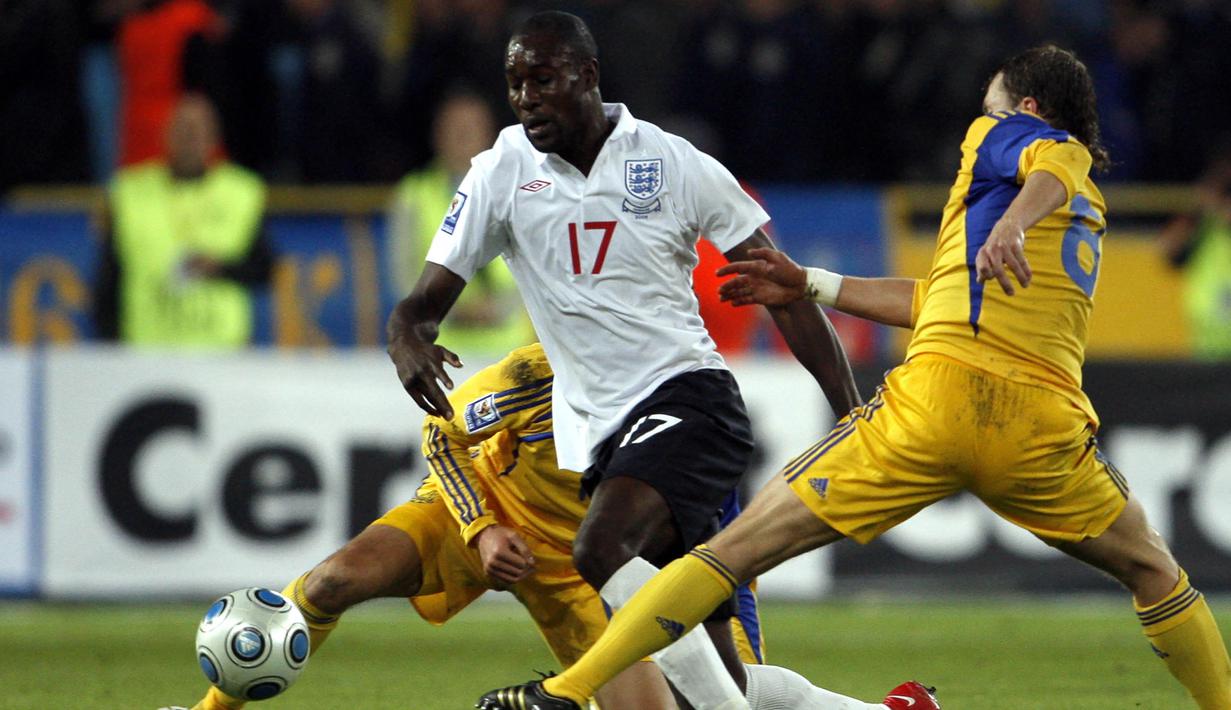 Striker Inggris, Carlton Cole, berusaha melewati pemain Ukraina, Olexiy Gay. Performa apiknya bersama West Ham membuat bomber kelahiran London ini sempat tujuh kali membela Inggris dibawah asuhan Fabio Capello. (AFP/Ian Kington)