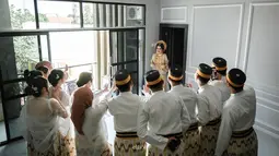 Bridesmaid dan groomsmen Nia terpukau ketika melihat Nia keluar dari kamar dengan berbalut baju adat Bugis. Meski ekspresinya tak terlihat karena membelakangi kamera, namun kebahagiaan tentunya dirasakan sahabat Nia jelang akad nikah Nia LIDA. Sederet sahabat pedangdut dengan nama asli Rusnia itu kompak unggah foto pernikahan Nia LIDA ini di laman Instagram pribadinya. (Liputan6.com/IG/@gunawan.lida2020)