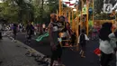 Anak-anak didampingi orangtua bermain di RPTRA Bhineka Jakarta Selatan, Sabtu (30/7/2022). Selain menjadi alternatif mengisi libur bersama keluraga, taman juga menjadi ruang bagi warga untuk berinteraksi sosial sekaligus mengeduksi anak untuk bermain bersama teman-teman dengan wahana yang tersedia. (Liputan6.com/Johan Tallo)