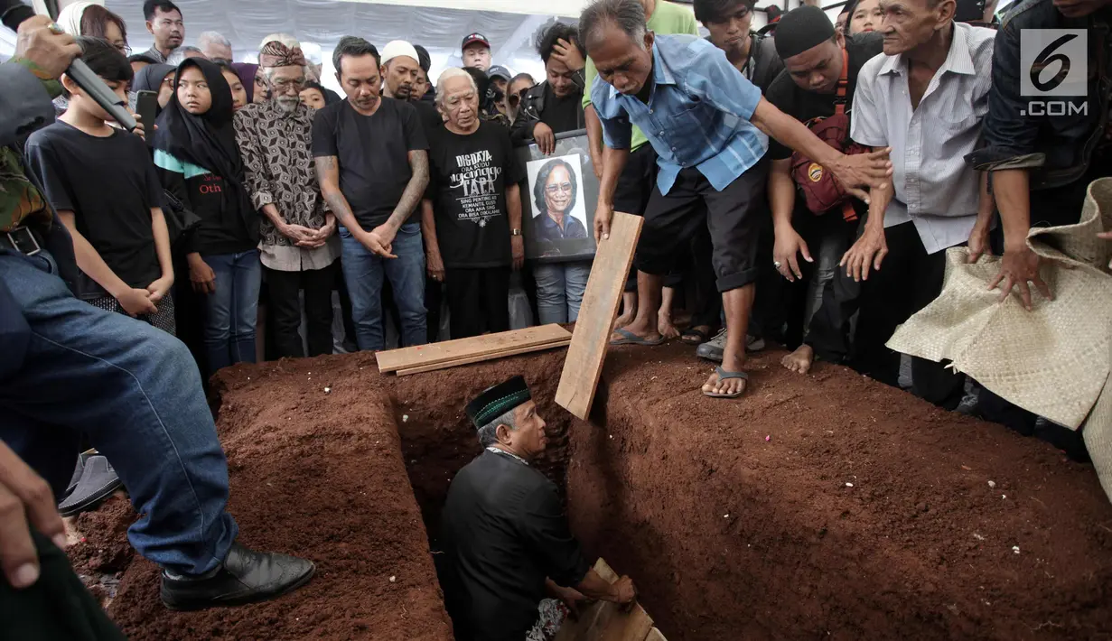 Suasana pemakaman Vokalis grup band legendaris Koes Plus, Yon Koeswoyo di TPU Tanah Kusir, Jakarta Selatan, Sabtu (6/1). Yon Koeswoyo dimakamkan bersama dengan almarhum kakaknya Tonny Koeswoyo. (Liputan6.com/Arya Manggala)