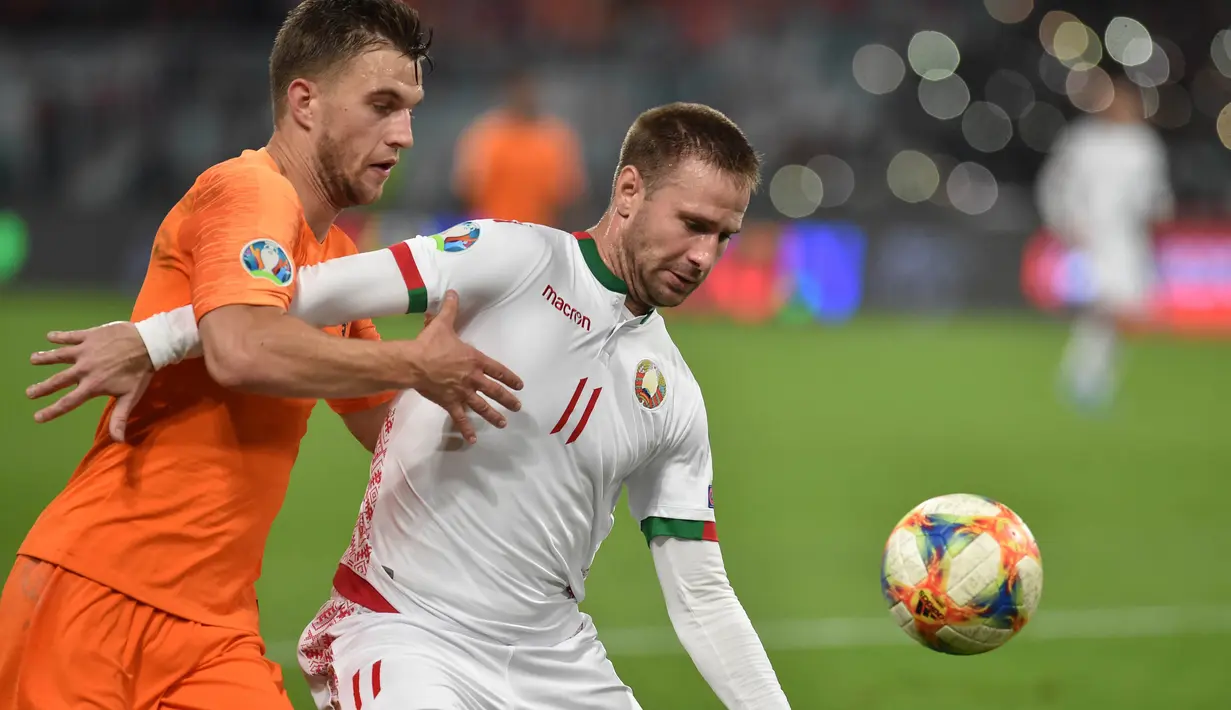 Bek Belanda, Joel Veltman, berebut bola dengan striker Belarusia, Maksim Skavysh, pada laga Kualifikasi Piala Eropa 2020 di Minsk, Minggu (13/10). Belarusia kalah 1-2 dari Belanda. (AFP/Sergei Gapon)