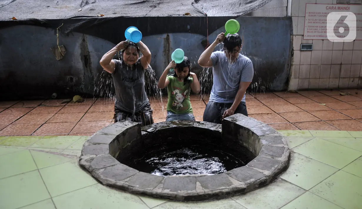 Warga keturunan Tionghoa membersihkan diri di salah satu sumur Vihara Gayatri, Depok, Jawa Barat, Minggu (15/1/2023). Jelang Tahun Baru Imlek, masyarakat keturunan Tionghoa mulai ramai mendatangi Vihara Gayatri untuk melakukan tradisi membersihkan diri di tujuh sumur yang diyakini dapat mendatangkan keberkahan. (merdeka.com/Iqbal S. Nugroho)